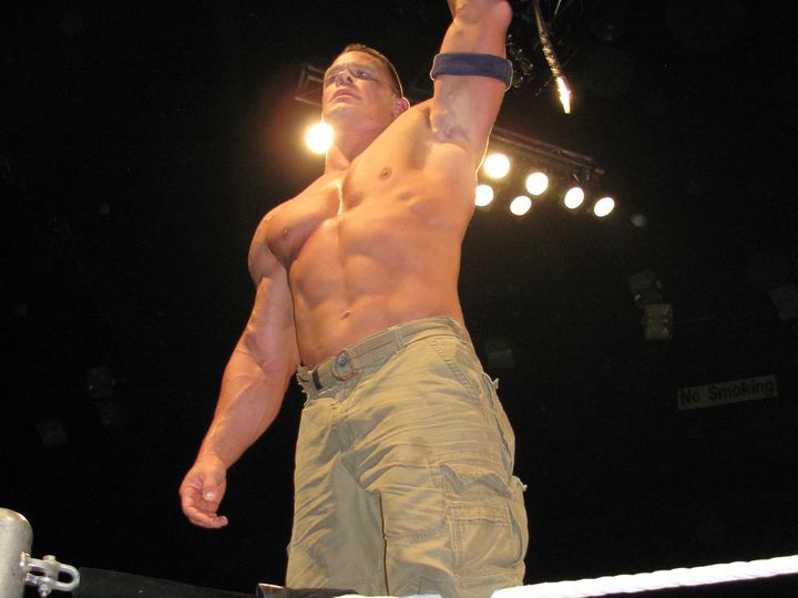 John Cena holding up the WWE Championship belt at a live event in Adelaide, Australia