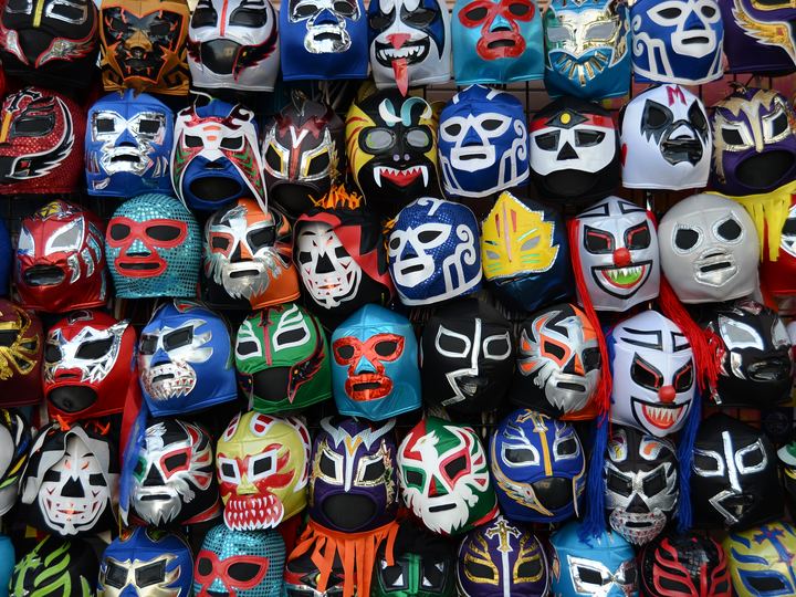 Rows of colorful Mexican lucha libre wrestling masks hanging for sale
