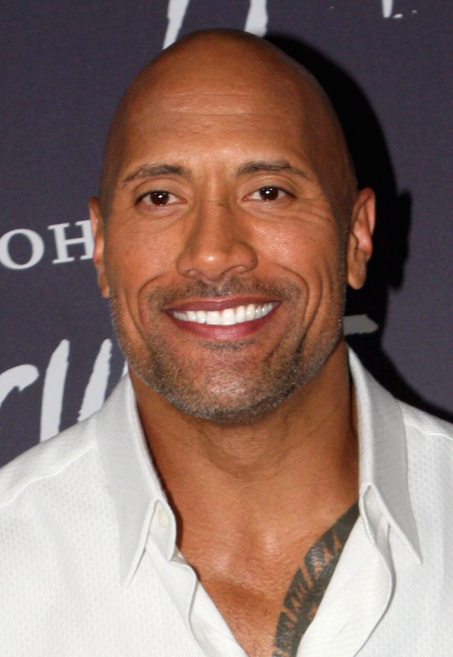 Dwayne Johnson smiling at a film premiere in Sydney in 2014